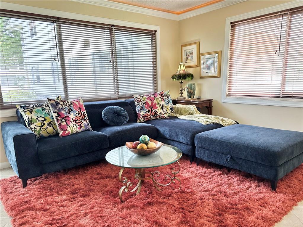 A living room features a blue sectional sofa, a glass coffee table, and a shaggy rug — 285 Oakridge Q # 285, Deerfield Beach FL 33442, DEERFIELD BEACH, FL
