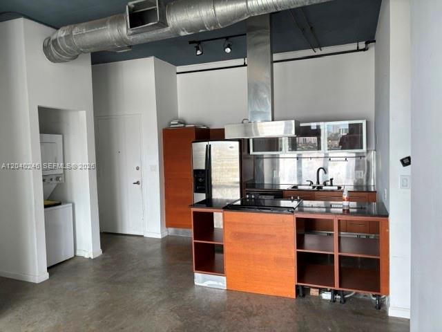 An industrial-style kitchen features wood cabinetry, stainless steel appliances, and exposed ductwork — 10 SW South River Dr # 1109, Miami FL 33130, MIAMI, FL