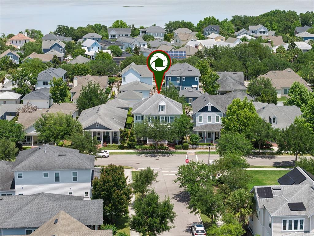 An aerial view shows a residential neighborhood with a green location pin marking a house — 907 EASLEY AVENUE, WINTER GARDEN, FL