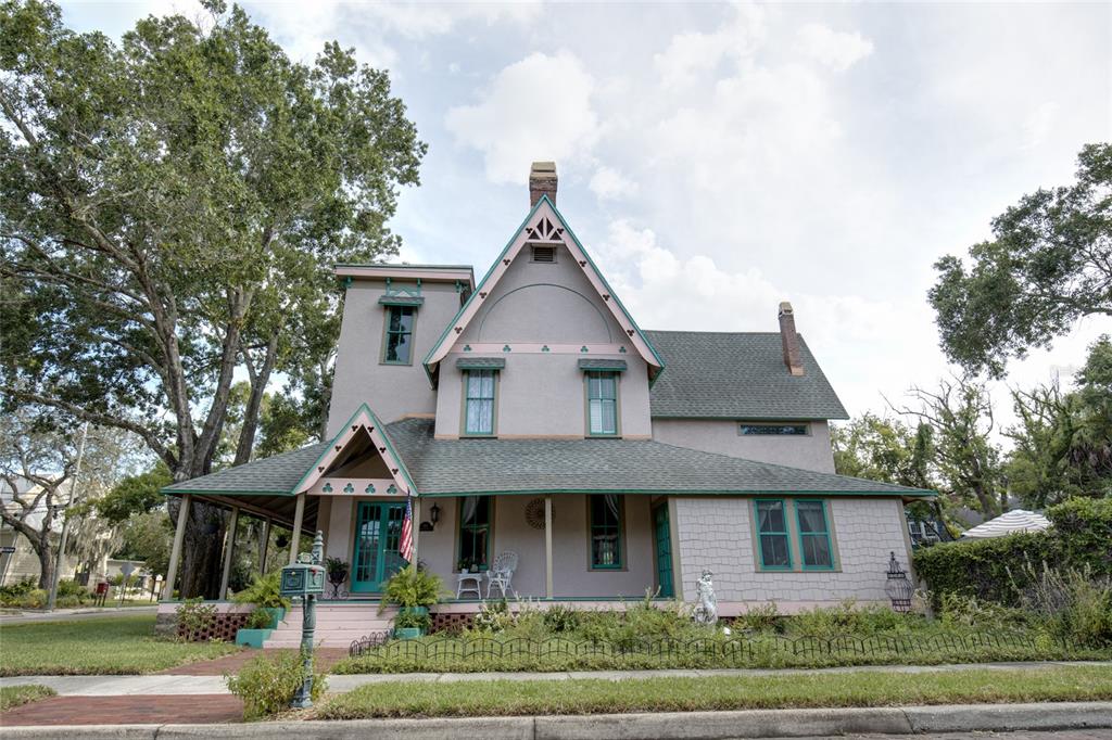 A two-story Victorian-style house with a wraparound porch, gabled roof, and light-colored exterior siding — 101 READ STREET, TARPON SPRINGS, FL