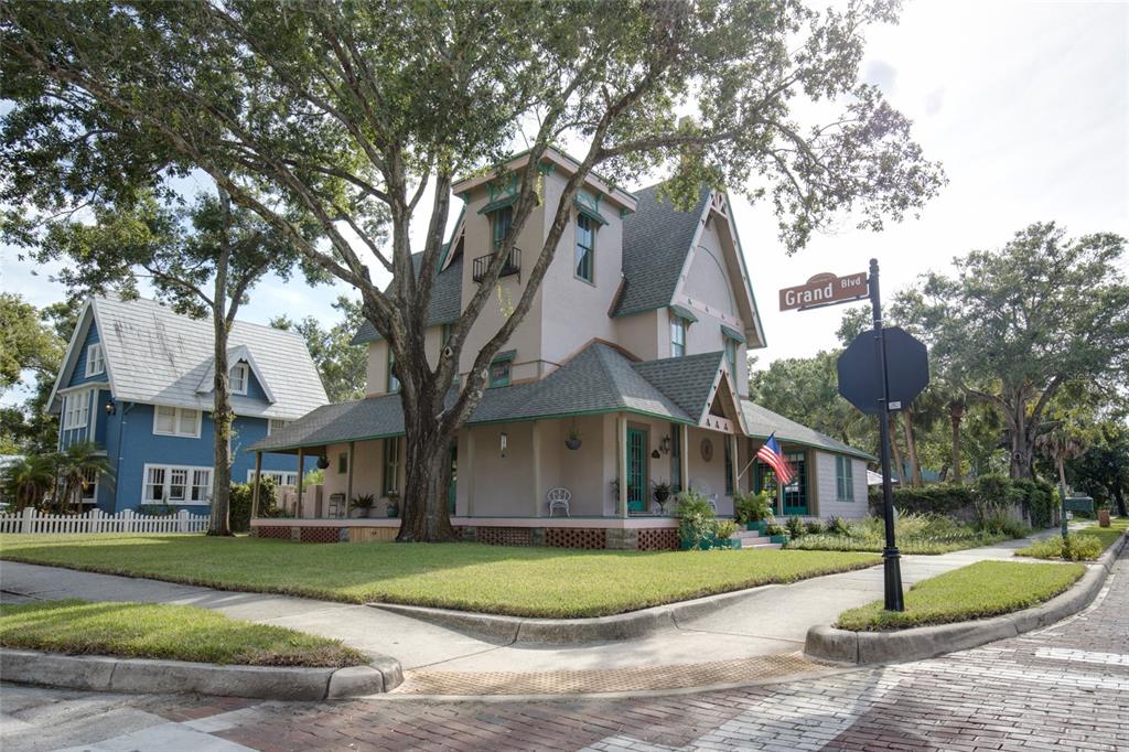 A two-story Victorian house with a wrap-around porch stands on a corner lot — 101 READ STREET, TARPON SPRINGS, FL