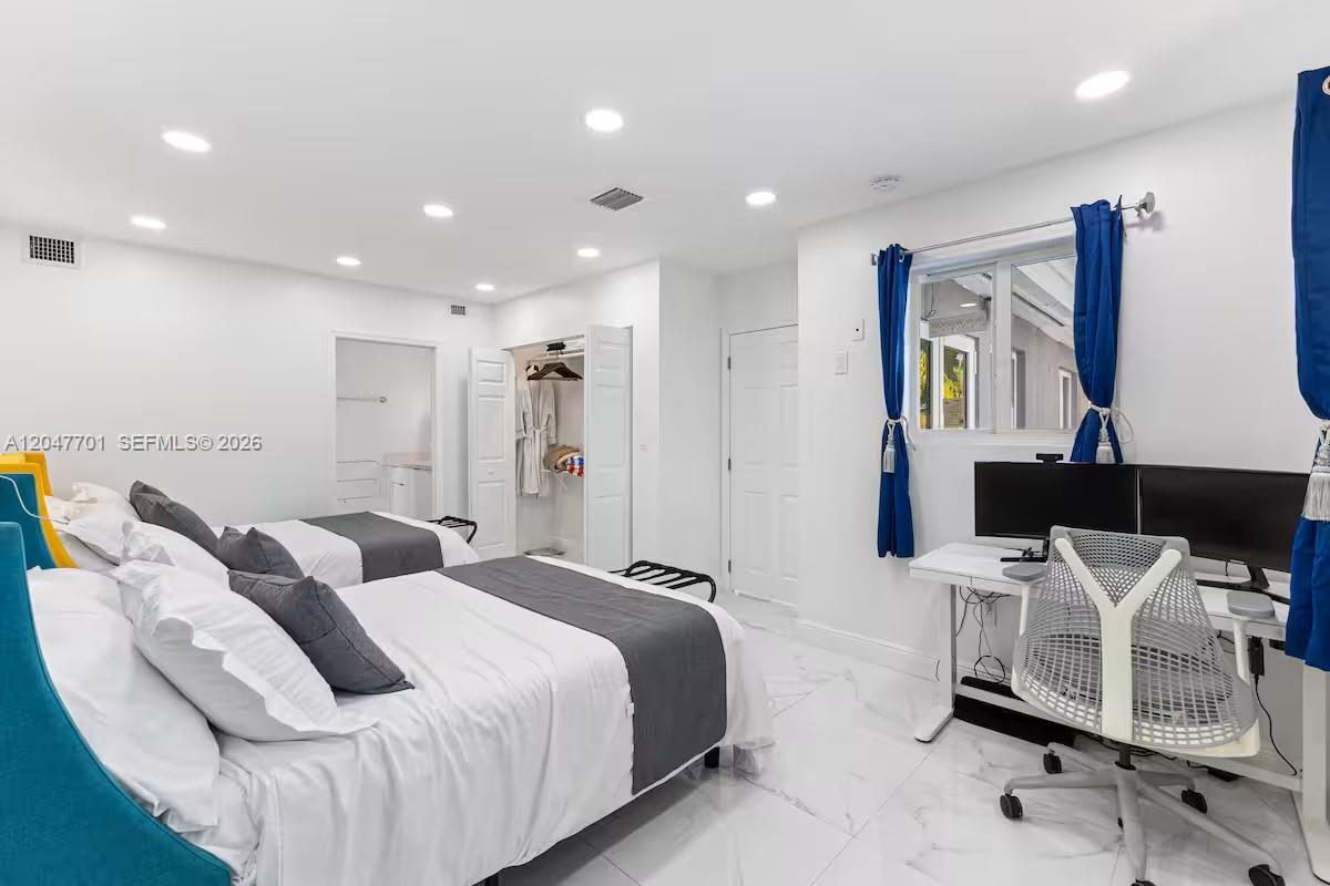 A bedroom features two beds, a desk with dual monitors, and white tile flooring — 1240 NE 159th St, North Miami Beach FL 33162, NORTH MIAMI BEACH, FL