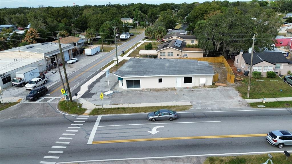 An aerial view shows a single-story commercial building with a parking lot at an intersection — 2595 AVENUE G NW, WINTER HAVEN, FL