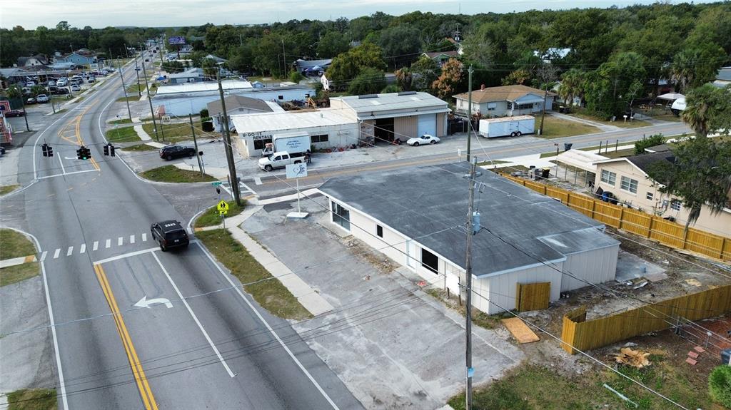 An aerial view shows a commercial building with a flat roof and adjacent parking lot — 2595 AVENUE G NW, WINTER HAVEN, FL
