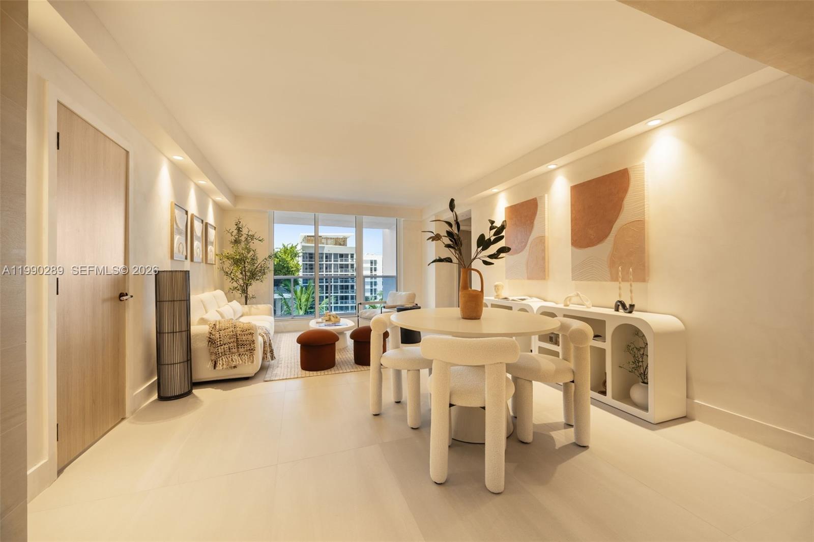 A bright living and dining area features modern furniture, neutral tones, and floor-to-ceiling windows — 2301 Collins Ave # 526, Miami Beach FL 33139, MIAMI BEACH, FL