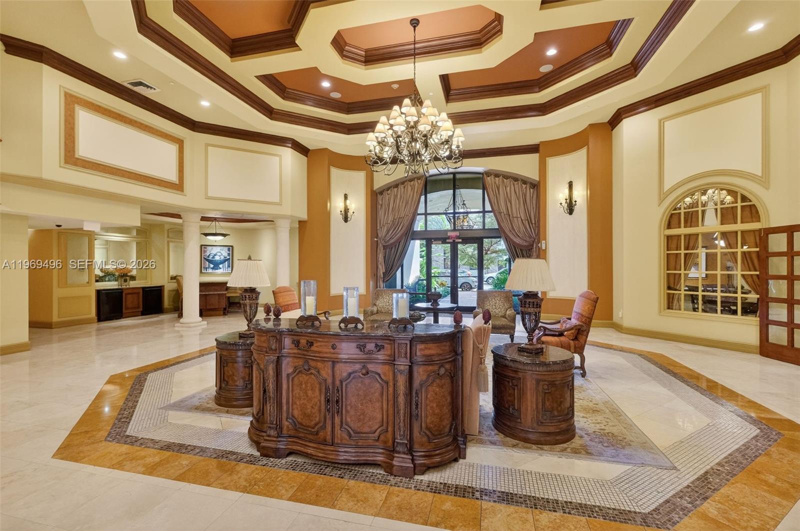 A grand lobby features a coffered ceiling, marble floors, and a central wooden console table — 888 S Douglas Rd # 1204, Coral Gables FL 33134, CORAL GABLES, FL