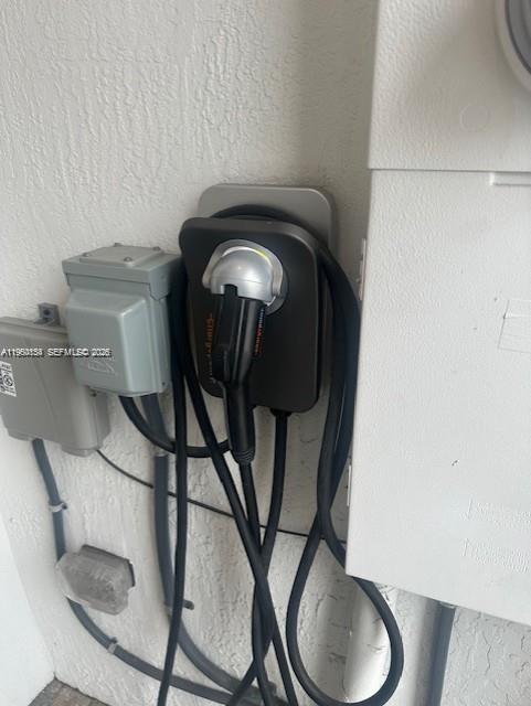 An electric vehicle charging station is mounted on an exterior wall next to electrical equipment — 8352 NW 7th Pl, Plantation FL 33324, PLANTATION, FL