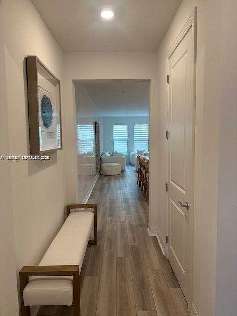 A hallway with light wood flooring leads to a living area with white furniture — 8352 NW 7th Pl, Plantation FL 33324, PLANTATION, FL
