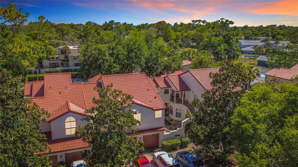 An aerial view shows a multi-story residential building with a red tile roof and parking — 535 VIA FONTANA DRIVE UNIT 202, ALTAMONTE SPRINGS, FL