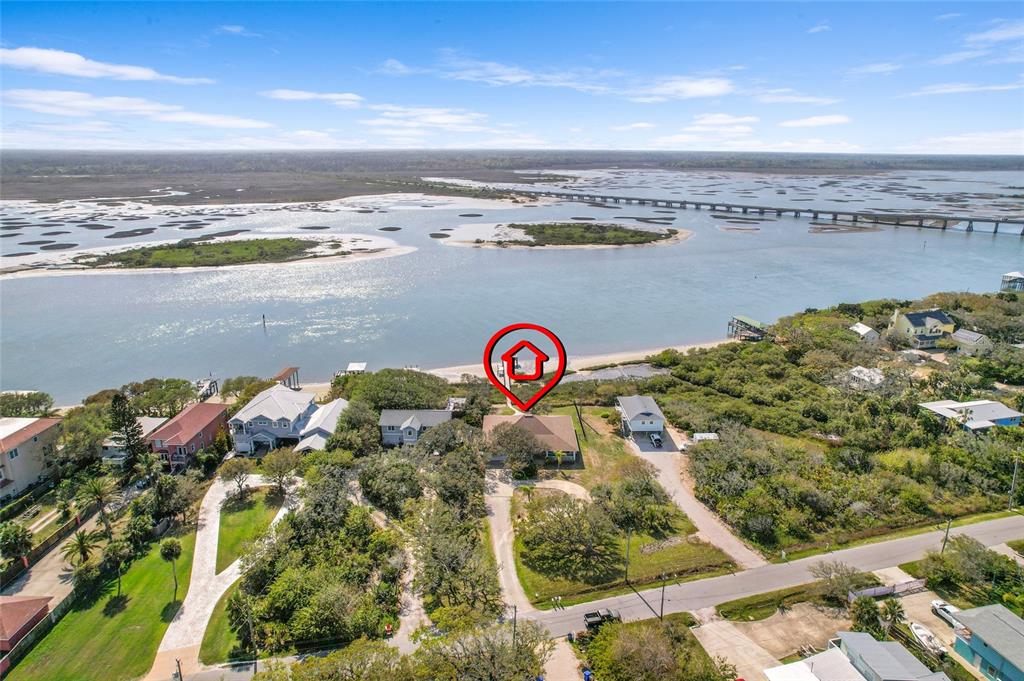 An aerial view shows a house with a red house icon located near a waterway — 7101 MIDDLETON AVENUE, ST AUGUSTINE, FL