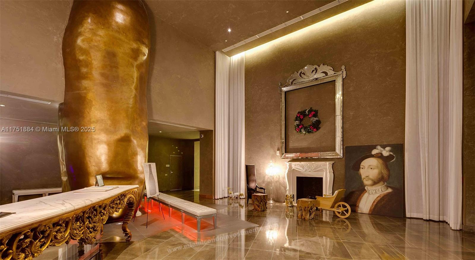 A grand lobby features a large gold sculpture, a fireplace, and a portrait painting — 465 Brickell Ave # 2405, Miami FL 33131, MIAMI, FL
