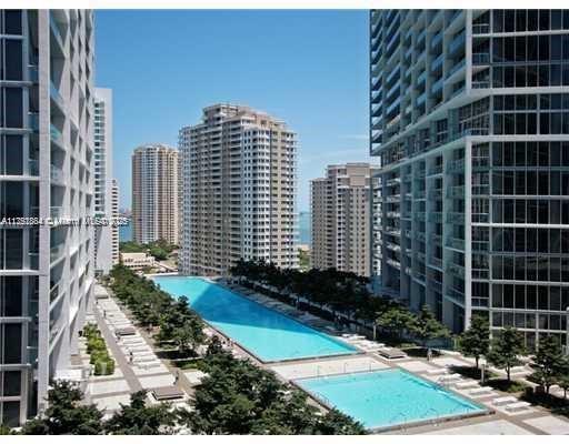 An elevated view of a swimming pool complex situated between several tall residential apartment buildings — 465 Brickell Ave # 2405, Miami FL 33131, MIAMI, FL