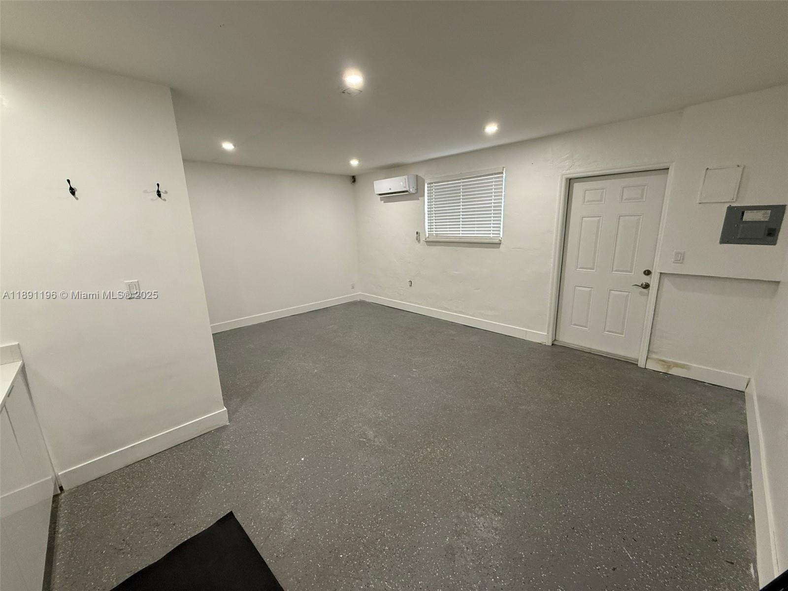 A room with white walls, a gray speckled floor, a window, and a door — 4300 NW 3rd Ct # 1, Plantation FL 33317, PLANTATION, FL