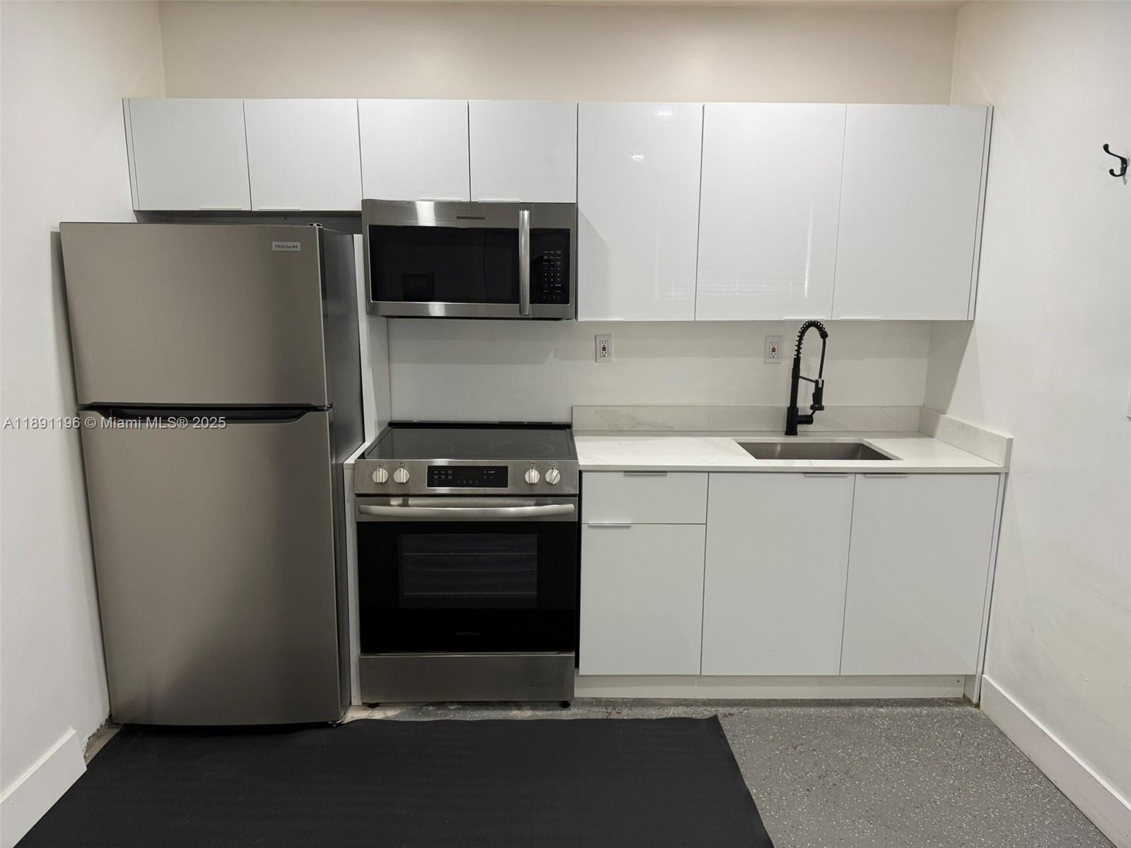 A kitchen features stainless steel appliances, white flat-panel cabinets, and a black faucet — 4300 NW 3rd Ct # 1, Plantation FL 33317, PLANTATION, FL