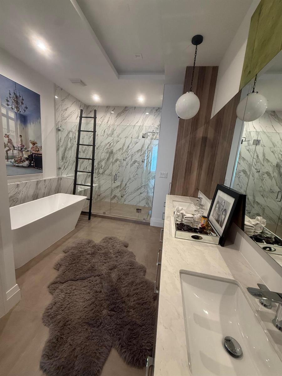 A modern bathroom features a freestanding tub, a glass-enclosed shower, and a double vanity — 1177 George Bush Boulevard # 207, Delray Beach FL 33483, DELRAY BEACH, FL