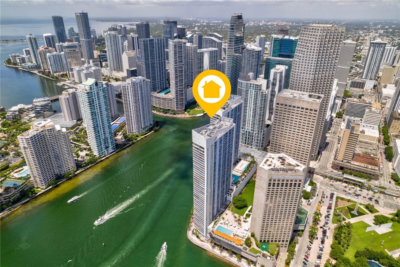 An aerial view of a tall residential skyscraper in downtown Miami near a river — 335 S Biscayne Blvd # 1006, Miami FL 33131, MIAMI, FL
