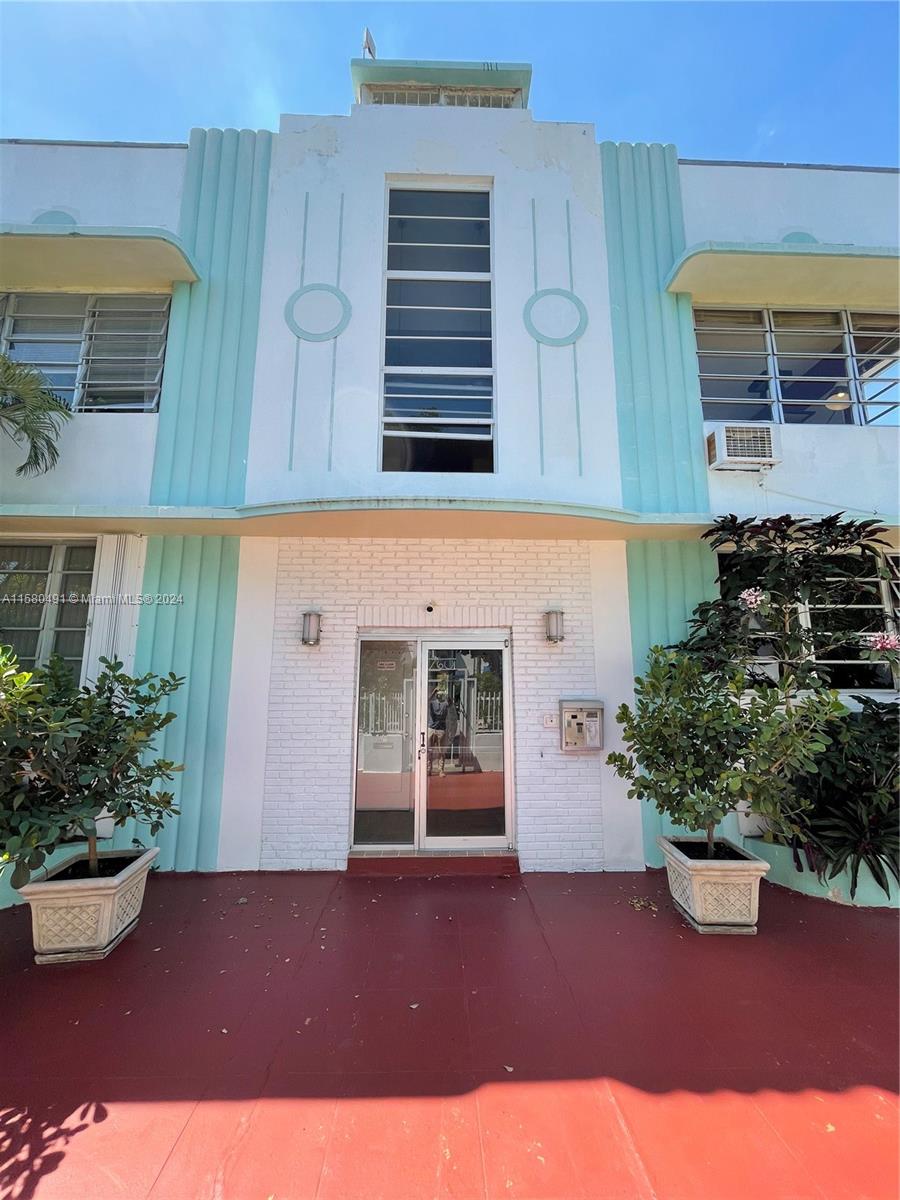The exterior of a two-story Art Deco building features a central entrance with glass doors — 760 Jefferson Ave # 11, Miami Beach FL 33139, MIAMI BEACH, FL