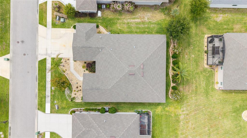 An aerial view shows a residential house with a gray shingled roof and landscaping — 4258 JAMES RIVER CIRCLE, LEESBURG, FL