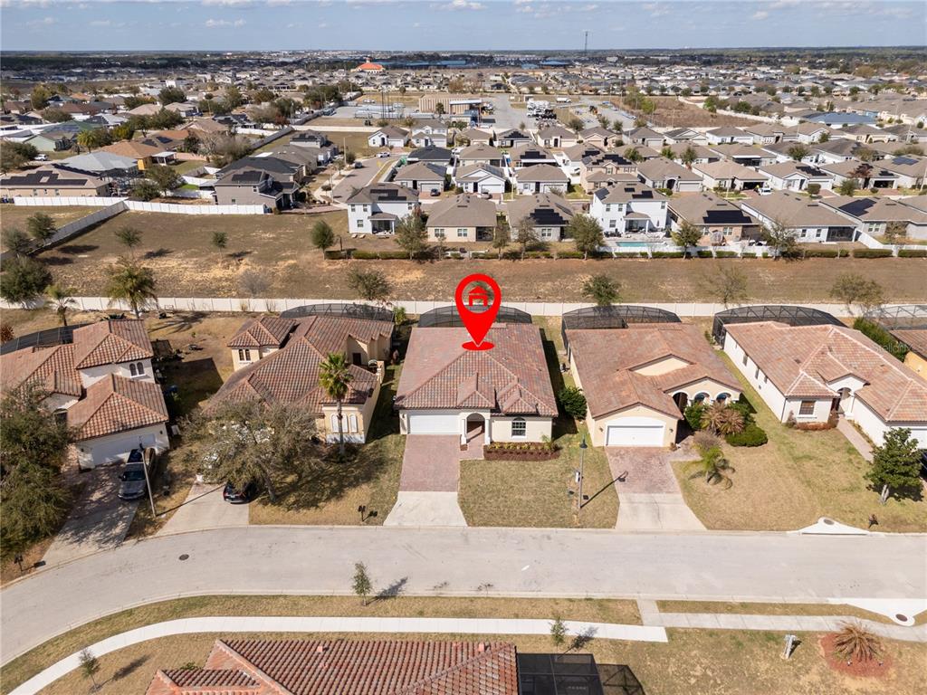 An aerial view shows a single-story suburban house with a tiled roof and screened-in patio — 355 VILLA SORRENTO CIRCLE, HAINES CITY, FL