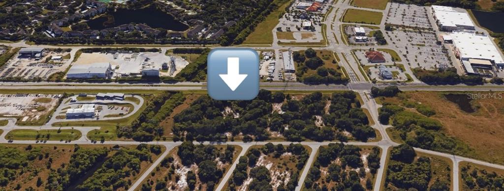 An aerial view of a vacant, wooded lot situated near commercial buildings and paved roads — 19400 VETERANS BOULEVARD UNIT 3, PORT CHARLOTTE, FL