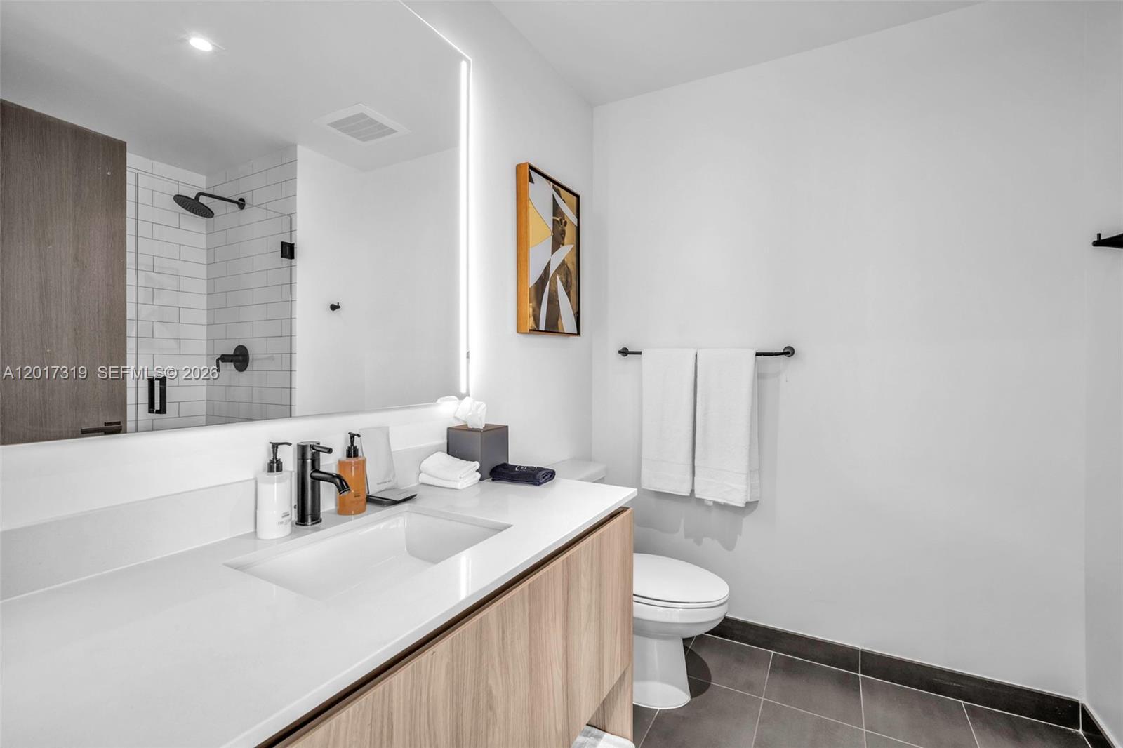 A modern bathroom features a white vanity, a large mirror, and a tiled shower area — 398 NE 5th St # 4701, Miami FL 33132, MIAMI, FL