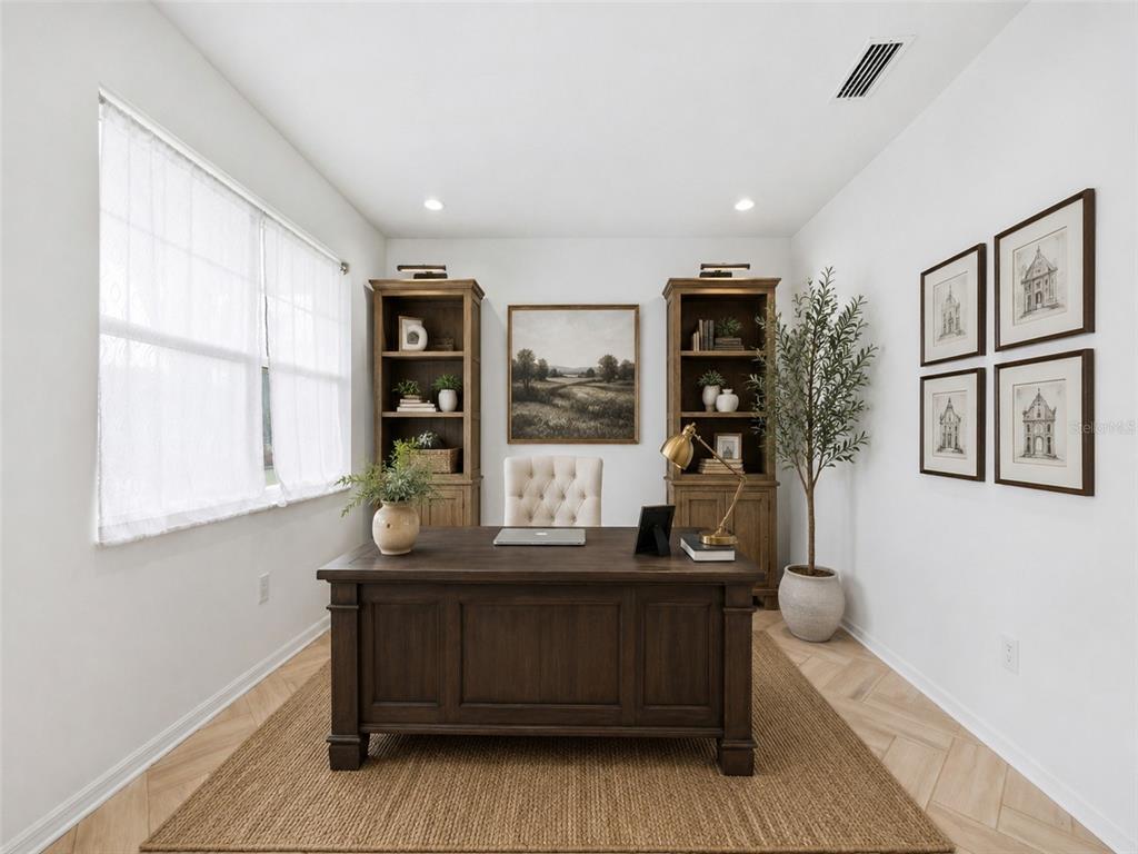 A home office features a dark wood desk, two matching bookcases, and a neutral area rug — 8326 ABALONE LOOP, PARRISH, FL