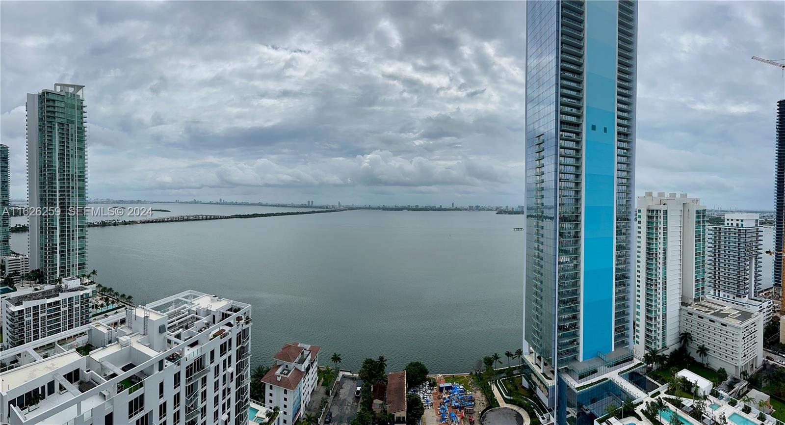 An elevated view of a bay surrounded by high-rise buildings under a cloudy sky — 600 NE 27th St # 2302, Miami FL 33137, MIAMI, FL