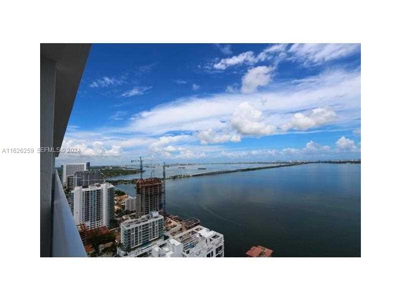 A high-angle view shows a coastal city skyline and a bridge spanning the water — 600 NE 27th St # 2302, Miami FL 33137, MIAMI, FL