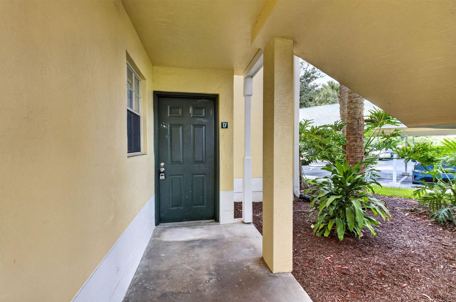 A dark green front door with a letter D sign sits under a covered entryway — 6339 La Costa Drive # D, Boca Raton FL 33433, BOCA RATON, FL