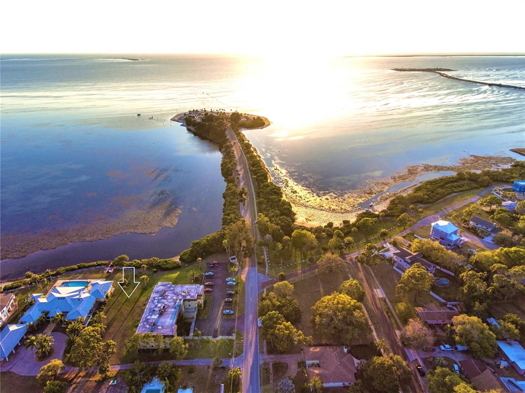 An aerial view shows a coastal road leading to a point surrounded by water — 1725 GULF ROAD, TARPON SPRINGS, FL