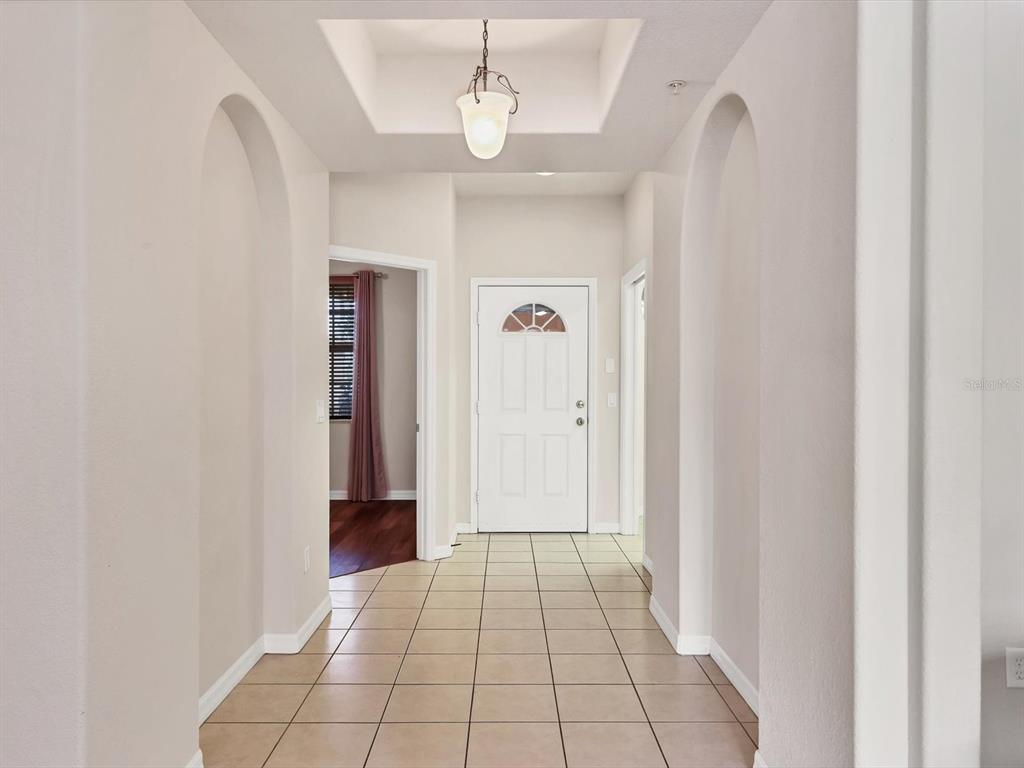 A tiled entryway features arched walls, a recessed ceiling, and a white front door — 150 L PAVIA BOULEVARD UNIT 13, VENICE, FL