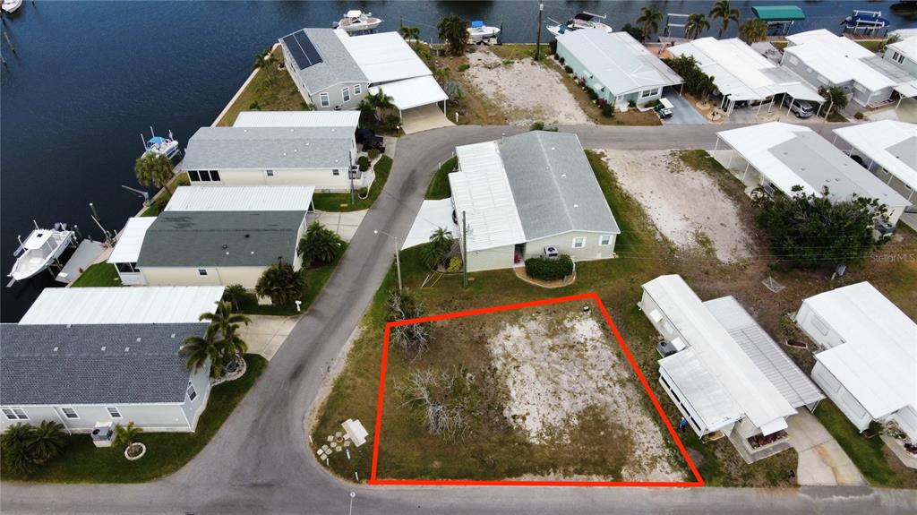 An aerial view shows a vacant rectangular lot outlined in red within a residential neighborhood — 269 JAMAICA DRIVE, PALMETTO, FL