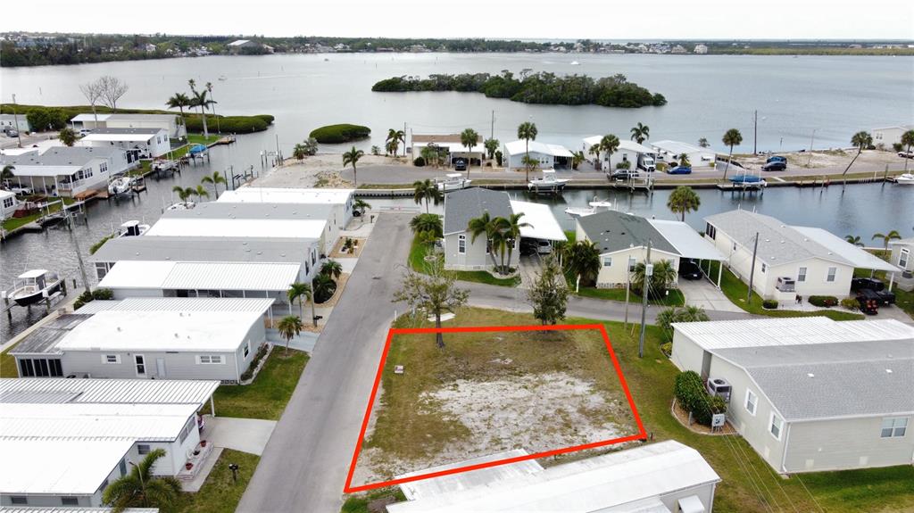 An aerial view shows a vacant, rectangular residential lot outlined in red within a neighborhood — 269 JAMAICA DRIVE, PALMETTO, FL
