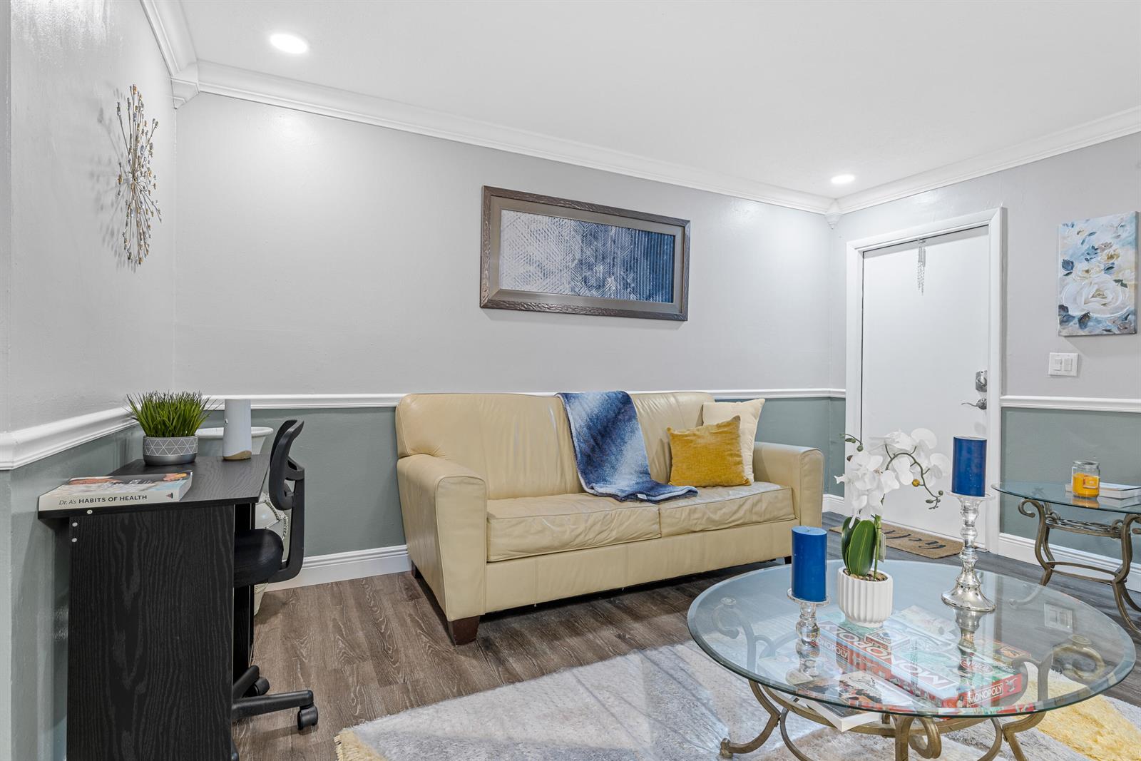 A living room features a beige sofa, a glass coffee table, and a black desk — 101 NE 4th Street # 3, Delray Beach FL 33444, DELRAY BEACH, FL