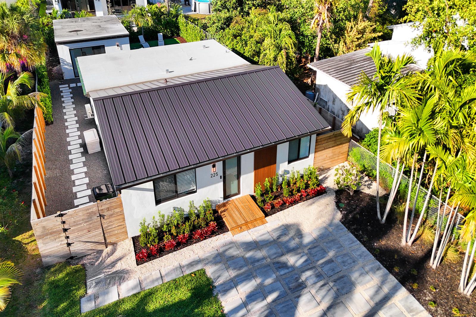 An aerial view shows a single-story house with a dark metal roof and landscaped yard — 225 NE 10th Street, Delray Beach FL 33444, DELRAY BEACH, FL