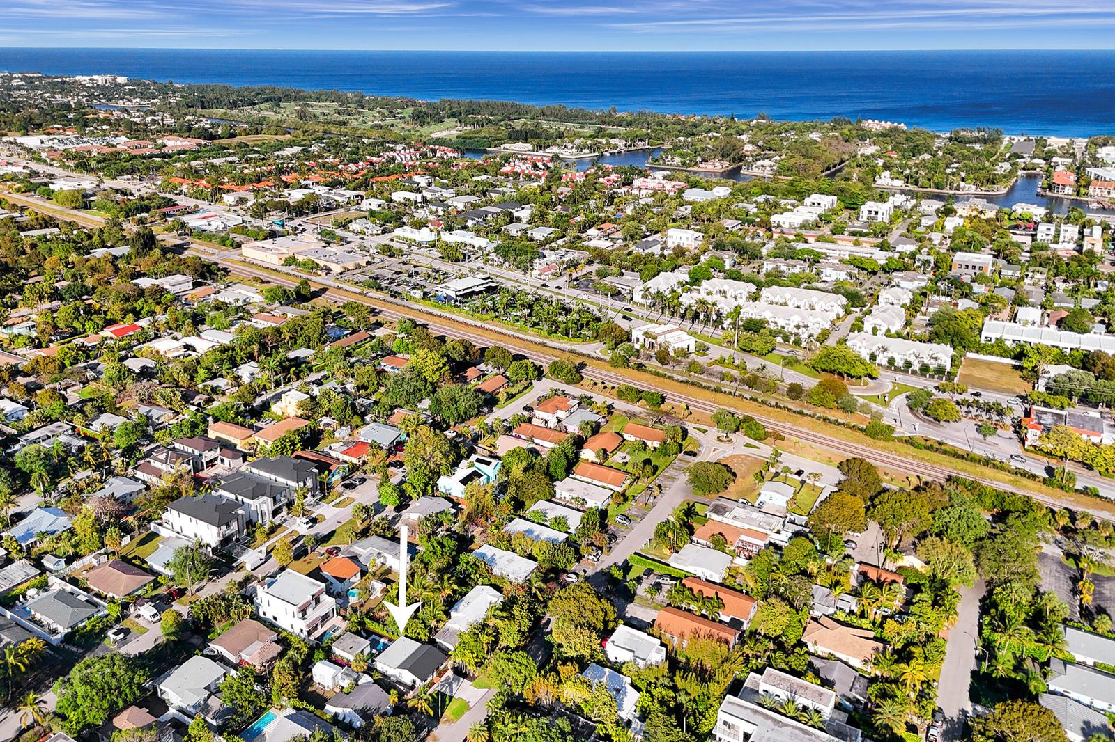 An aerial view shows a residential neighborhood with a white arrow pointing to a house — 225 NE 10th Street, Delray Beach FL 33444, DELRAY BEACH, FL
