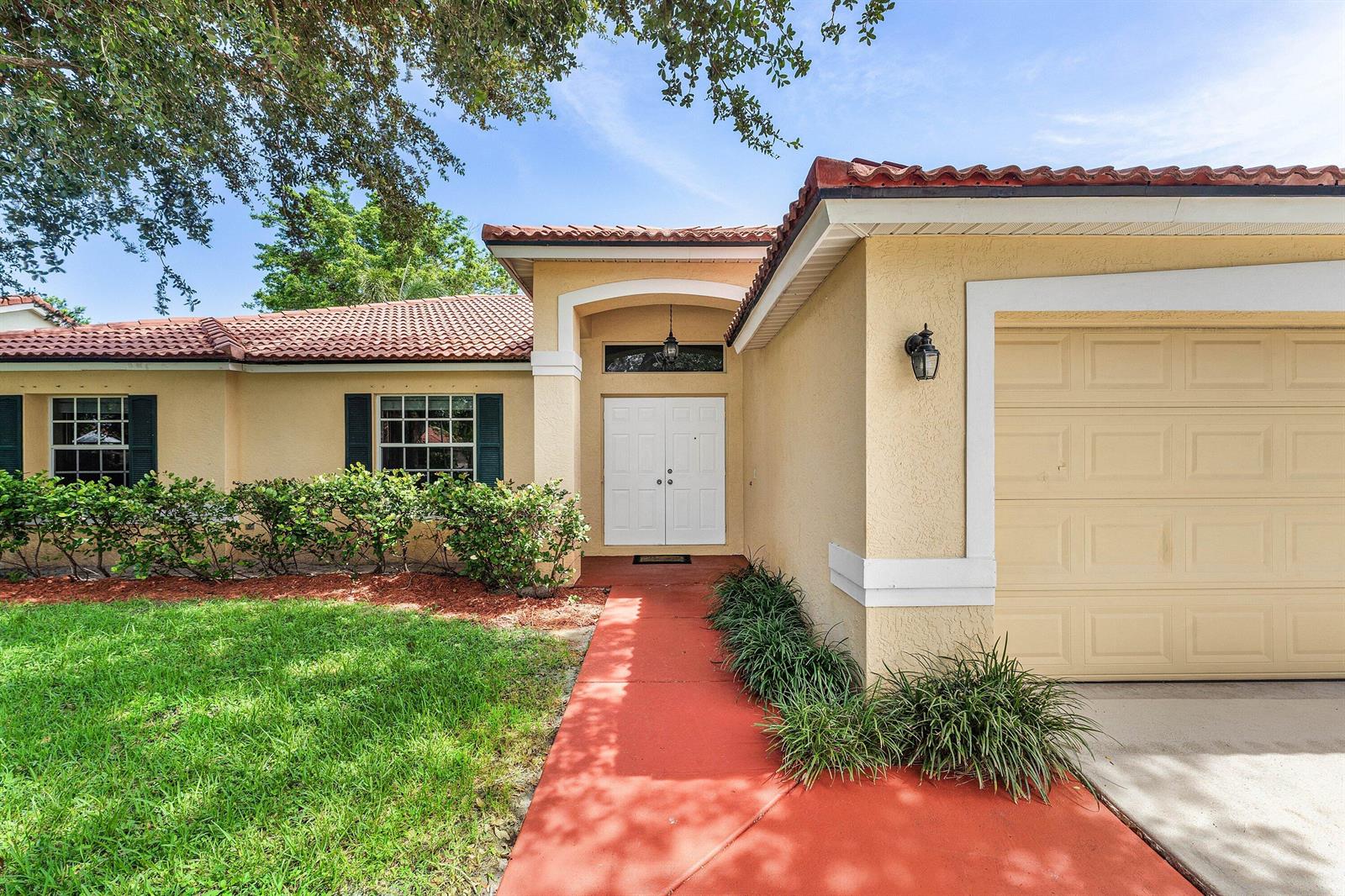 A single-story house with a red tile roof, beige stucco walls, and a double-door entrance — 4824 S Lee Road, Delray Beach FL 33445, DELRAY BEACH, FL