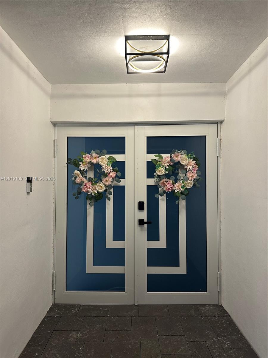 A double front door with floral wreaths is set within a white entryway — 11701 SW 21st Ct, Davie FL 33325, DAVIE, FL