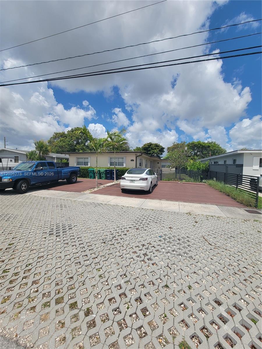 A white car and a blue pickup truck are parked on a paved driveway — 1052 SW 79th Ave, Miami FL 33144, MIAMI, FL