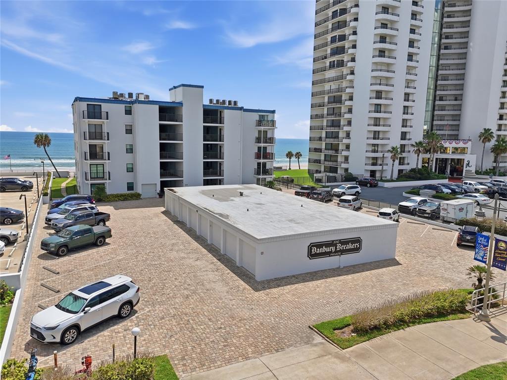 An elevated view shows a parking lot with a storage building and two apartment towers — 3747 S ATLANTIC AVENUE UNIT 4050, DAYTONA BEACH, FL