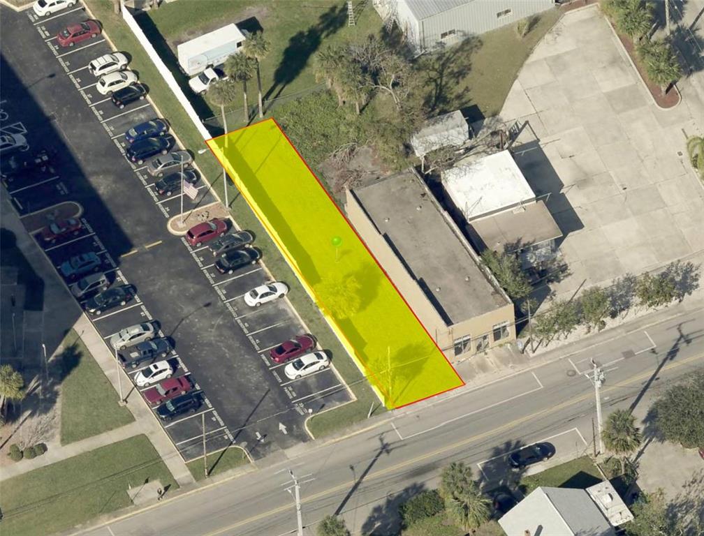 An aerial view shows a rectangular vacant lot highlighted in yellow next to a building — 112 FAIRVIEW AVENUE, DAYTONA BEACH, FL