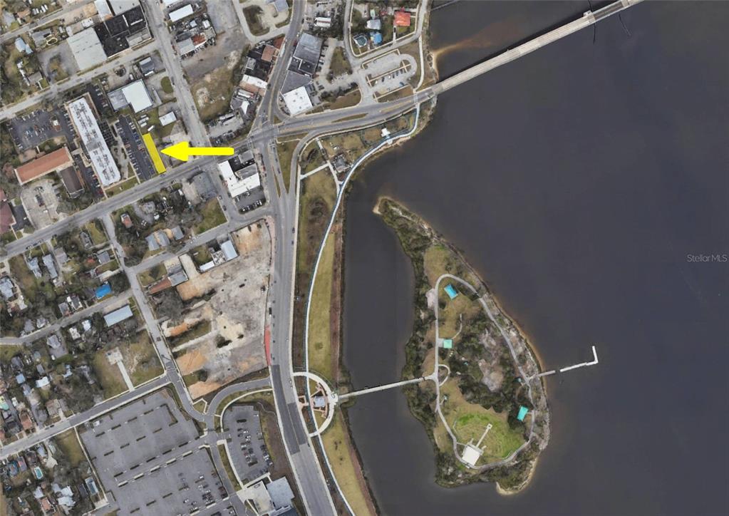 This is an aerial map view showing a highlighted property lot near a waterfront park — 112 FAIRVIEW AVENUE, DAYTONA BEACH, FL