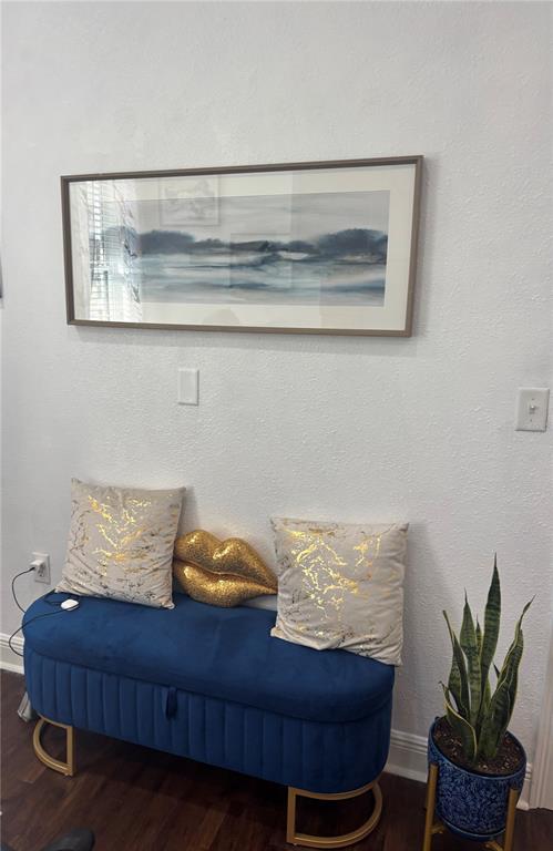 A blue velvet bench with gold accents sits below a framed landscape painting — 3830 TURMAN LOOP, WESLEY CHAPEL, FL