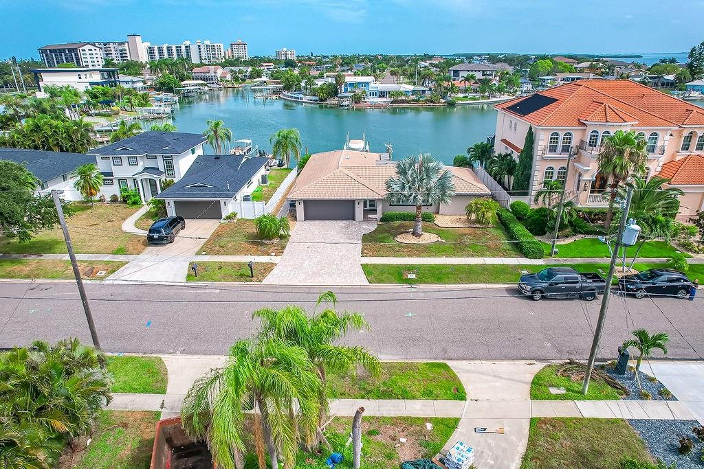 An aerial view of a waterfront house with a paved driveway and a tiled roof — 340 PALM ISLAND NE, CLEARWATER BEACH, FL