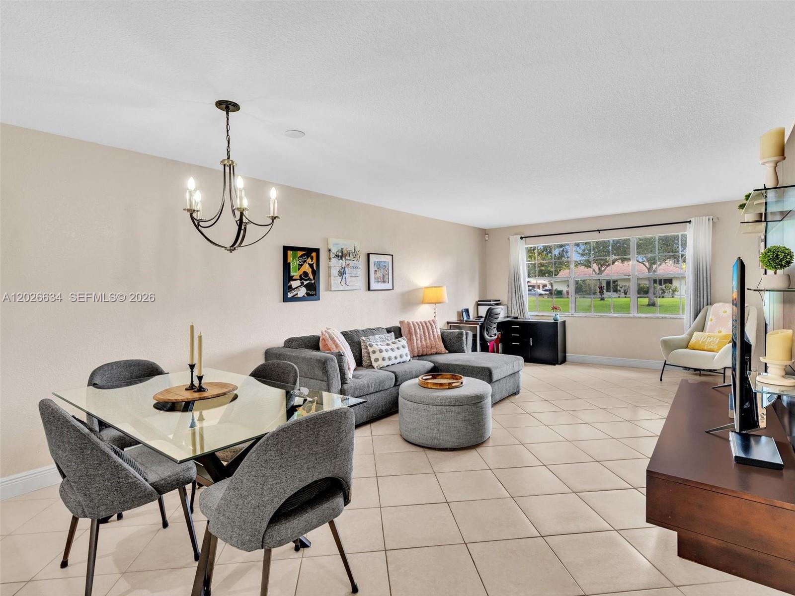 A living and dining area features tile flooring, a grey sectional sofa, and a glass table — 3660 Citrus Trce # 2, Davie FL 33328, DAVIE, FL