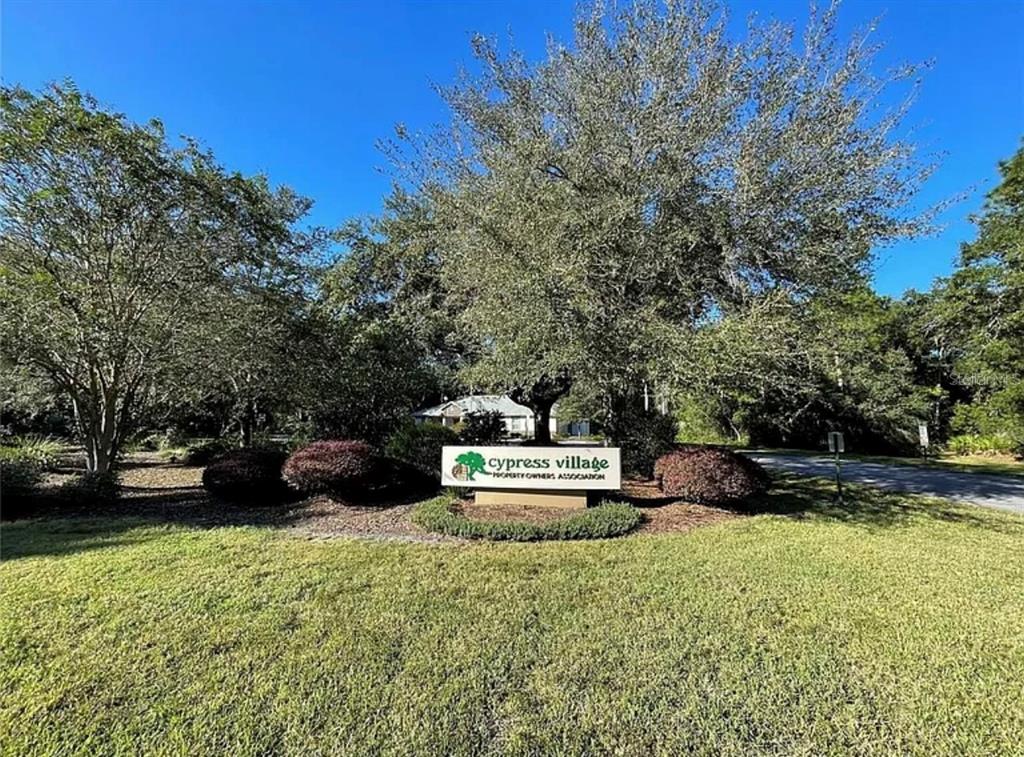 A sign for Cypress Village Property Owners Association stands in a grassy area with trees — 16 MAYTEN COURT N, HOMOSASSA, FL