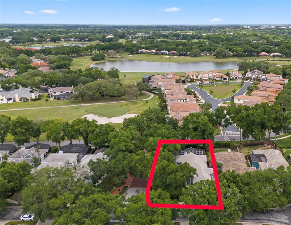 An aerial view shows a residential house highlighted by a red border near a golf course — 1250 E LANGLEY COURT, LAKE MARY, FL