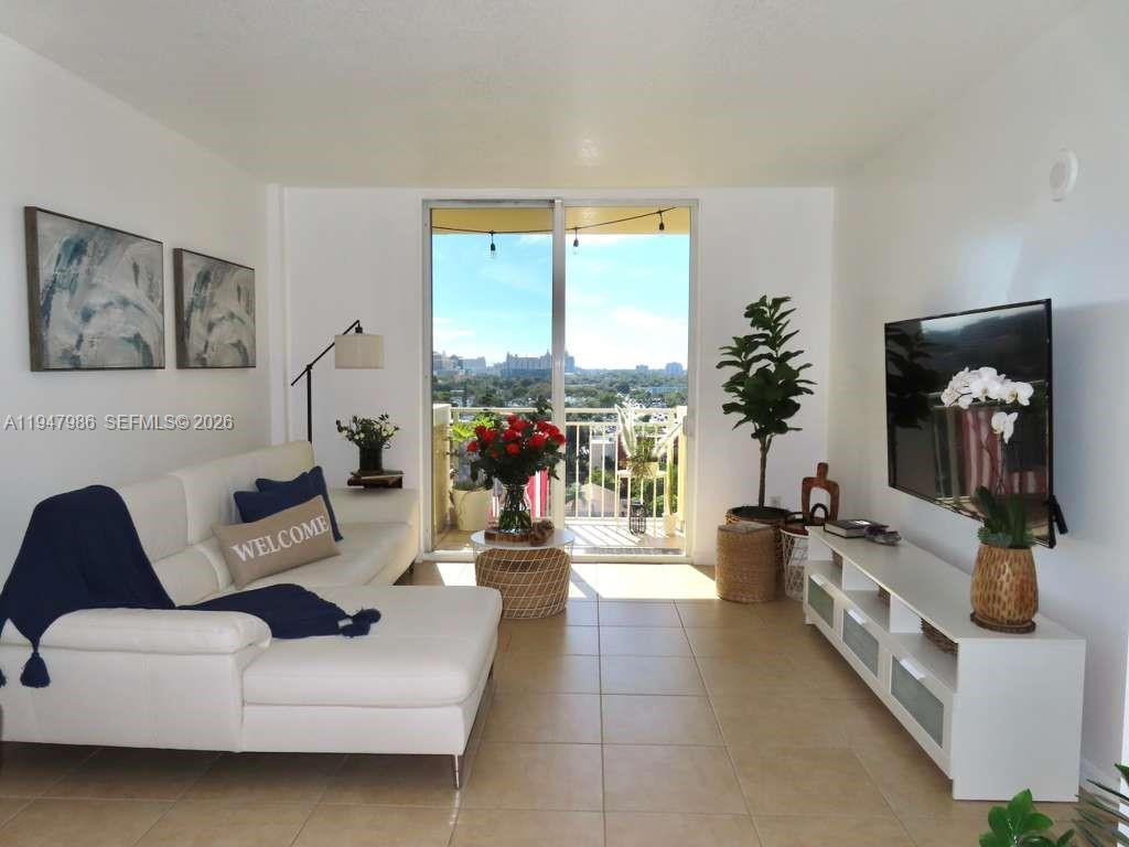 A balcony with a white column overlooks a city landscape during a sunset — 215 SW 42nd Ave, Miami FL 33134, MIAMI, FL