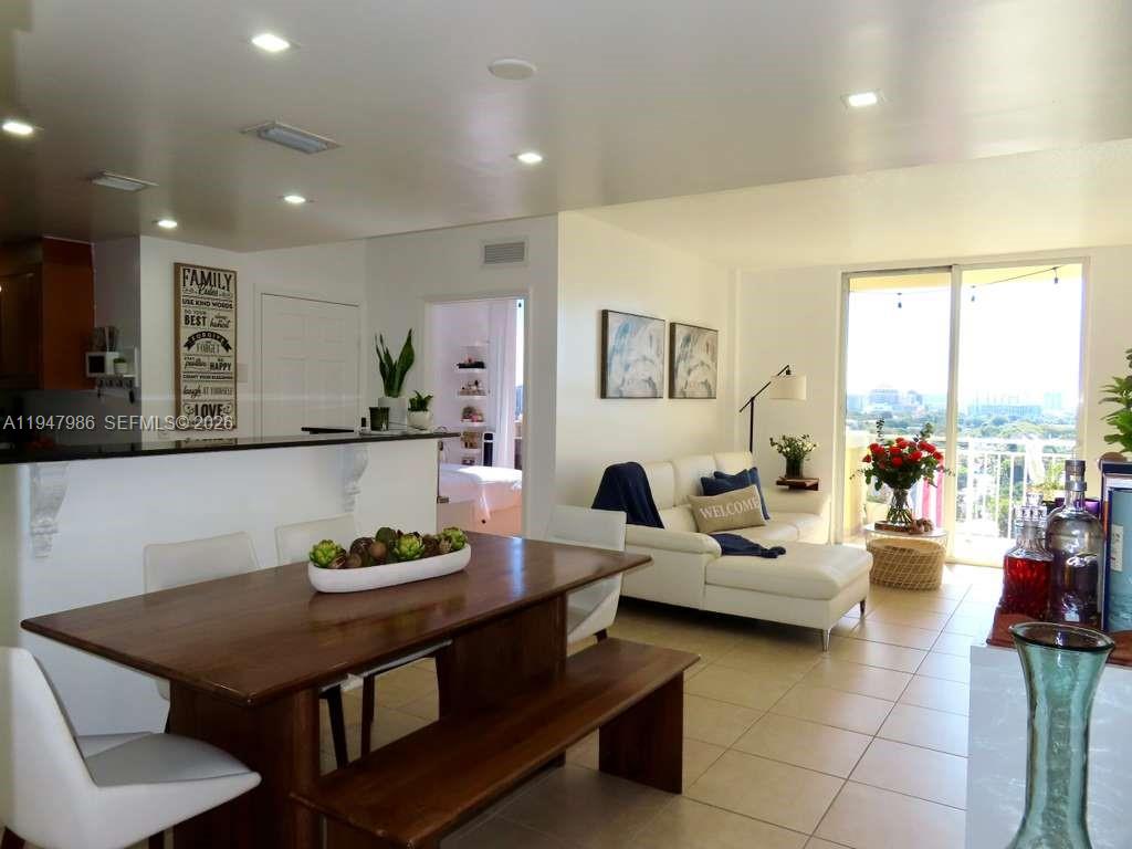 A balcony features a stainless steel grill, a serving tray with wine, and city views — 215 SW 42nd Ave, Miami FL 33134, MIAMI, FL