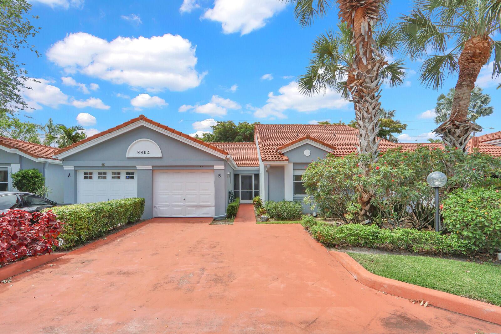 A single-story house with a terracotta roof, gray siding, and a red concrete driveway — 9904 Summerbrook Terrace # B, Boynton Beach FL 33437, BOYNTON BEACH, FL